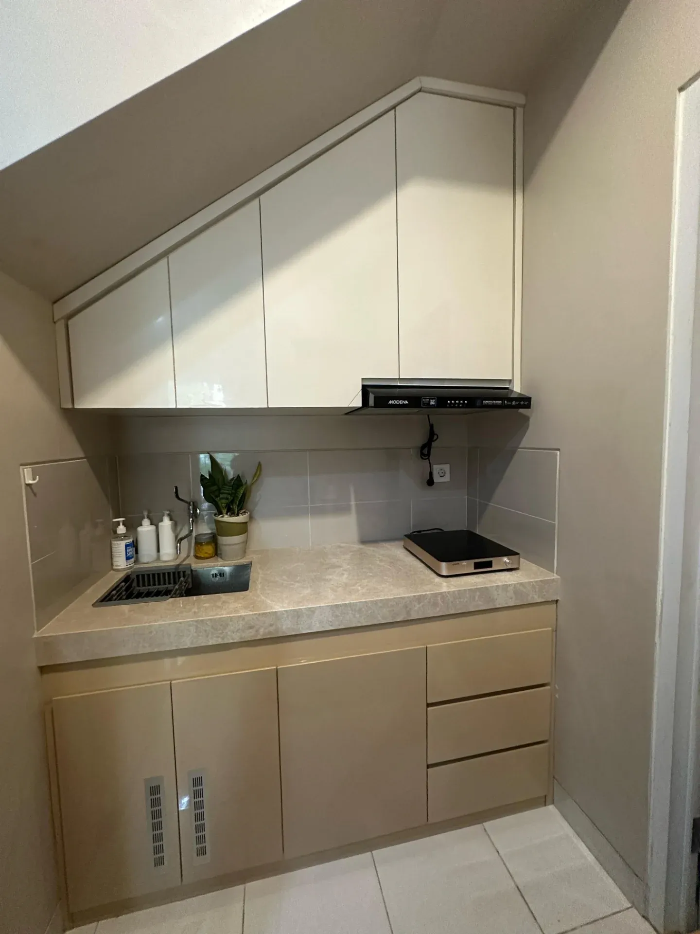 Kitchen set bawah tangga dilihat dari depan, dengan kompor tanam dan laci bawah